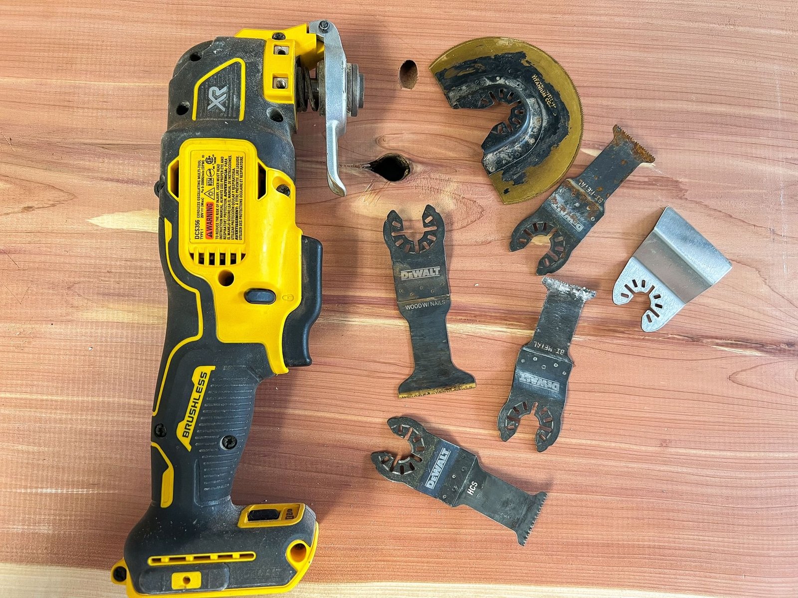 Stainless steel multitool with pliers and blade on a wooden workbench
