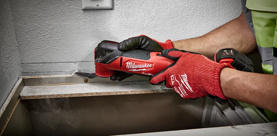 Unfolded multitool with pliers and knife blade on a workbench